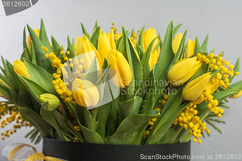 Image of Bright spring bouquet of tulips and mimosa flowers