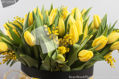 Image of Bright spring bouquet of tulips and mimosa flowers