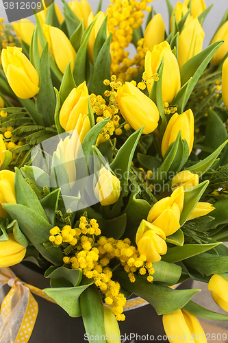 Image of Bright spring bouquet of tulips and mimosa flowers