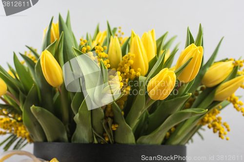 Image of Bright spring bouquet of tulips and mimosa flowers