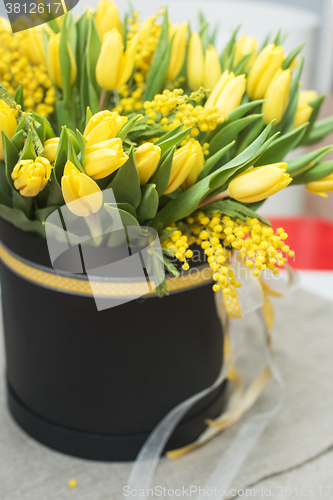 Image of Bright spring bouquet of tulips and mimosa flowers