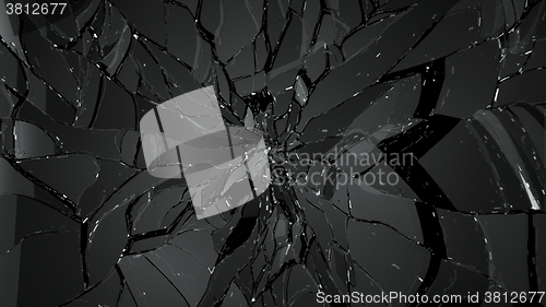 Image of Pieces of cracked glass on black