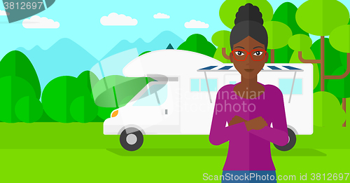 Image of Woman standing in front of motor home.