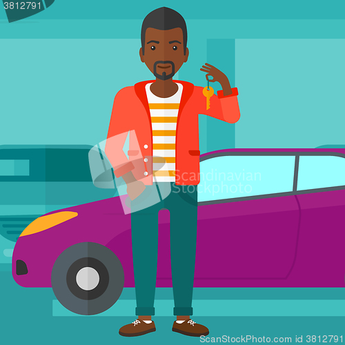 Image of Man holding keys from new car.
