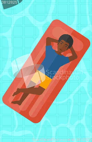 Image of Man relaxing in swimming pool.