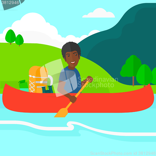 Image of Man canoeing on the river.