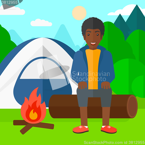 Image of Man sitting at camp.