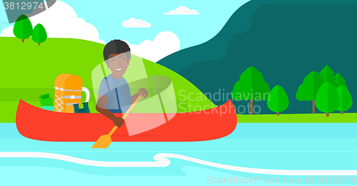 Image of Man canoeing on the river.