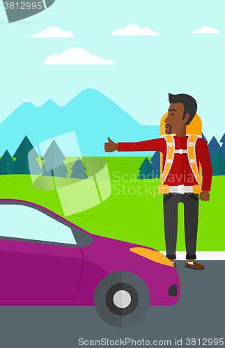 Image of Young man hitchhiking.