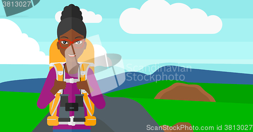 Image of Cheerful backpacker with binoculars.