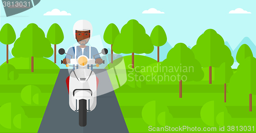 Image of Man riding scooter.