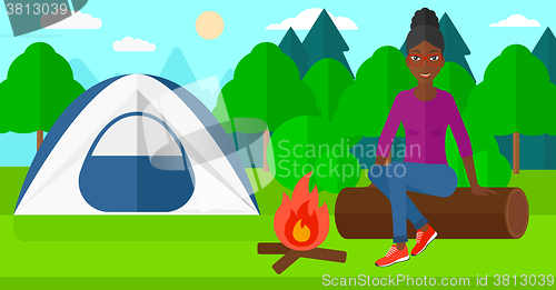 Image of Woman sitting at camp.