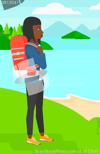 Image of Woman with backpack hiking.