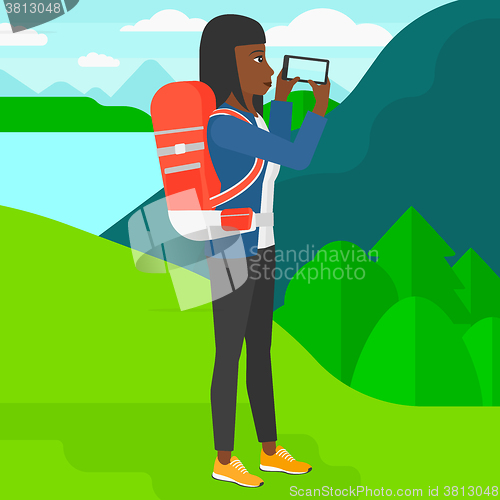 Image of Backpacker taking photo.