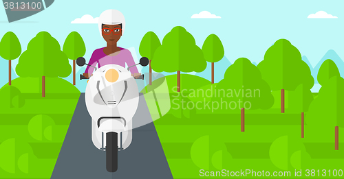 Image of Woman riding scooter.