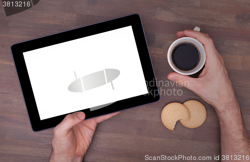 Image of Tablet touch computer gadget on wooden table