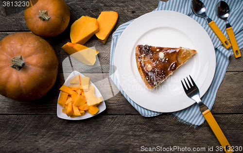 Image of Rustic style Pumpkin slices and piece of pie  