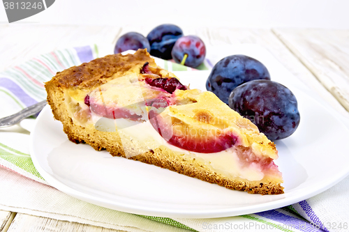 Image of Pie plum with sour cream in plate on light board