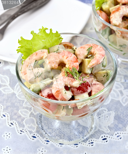 Image of Salad with shrimp and tomatoes in glass on table