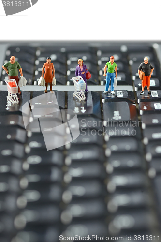 Image of Shoppers  race with shopping cart on a computer keyboard