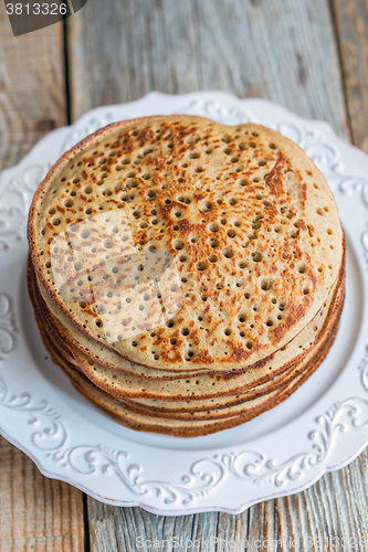 Image of Pancakes from wholemeal flour on a plate. View from above.