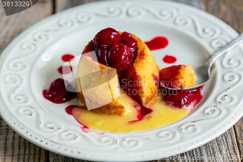 Image of Dessert White chocolate with cherry sauce.