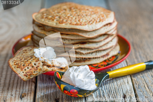 Image of Pancakes from wholemeal flour and spoon sour cream.