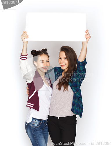 Image of smiling teenage girls holding white blank board