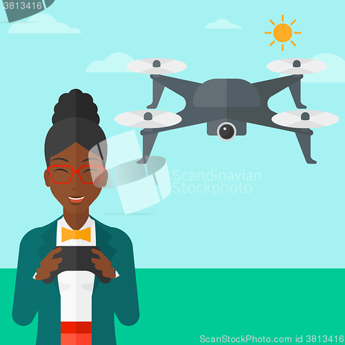 Image of Woman flying drone.