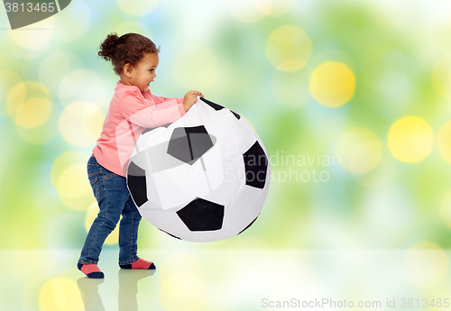 Image of happy mulatto little baby girl playing with ball