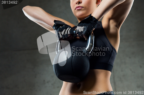 Image of close up of woman with kettlebell in gym