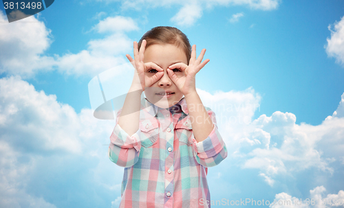 Image of happy little girl making faces and having fun