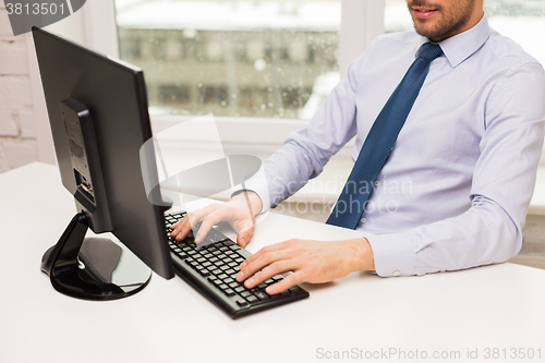 Image of close up of businessman hands typing on keyboard