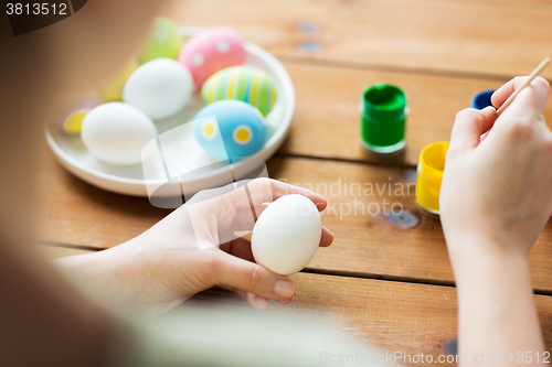 Image of close up of woman coloring easter eggs