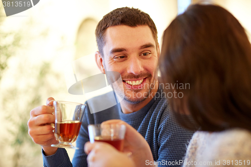 Image of happy couple drinking tea at cafe
