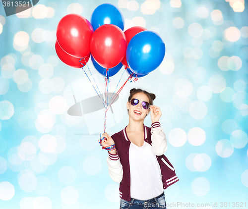 Image of happy teenage girl with helium balloons