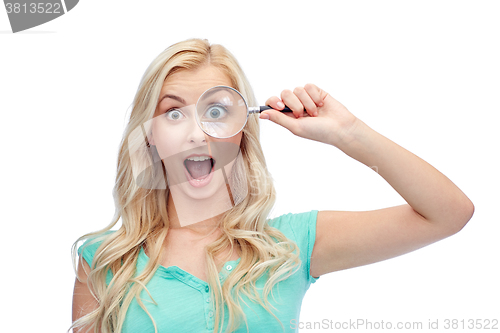 Image of happy young woman with magnifying glass