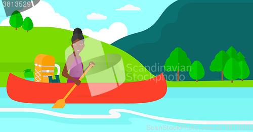 Image of Woman canoeing on the river.