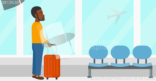 Image of Man at airport with suitcase.