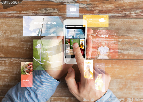 Image of close up of male hands with smartphone on table