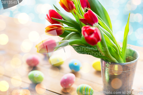 Image of close up of easter eggs and flowers in bucket