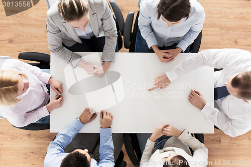 Image of close up of business team sitting at table