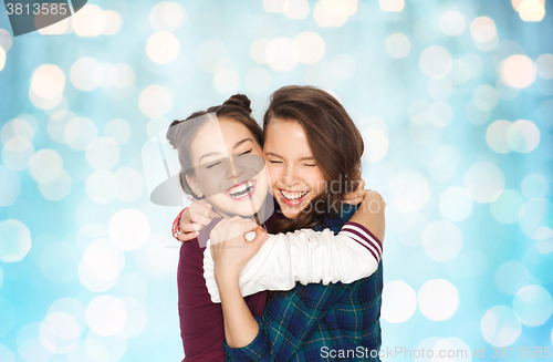 Image of happy smiling pretty teenage girls hugging