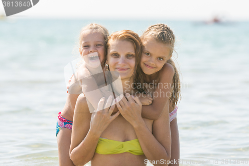 Image of Mother and two daughters swimming in the sea
