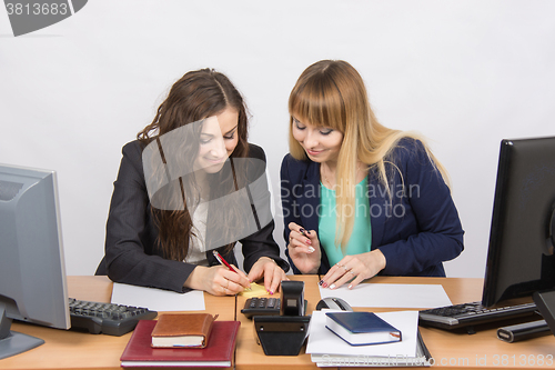 Image of Employees of the office fun writing something on paper for notes