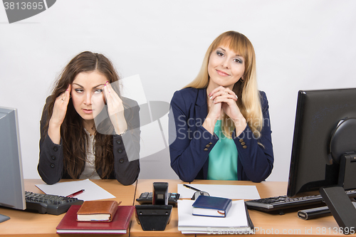 Image of The situation in the office - the girl was very tired from his colleagues