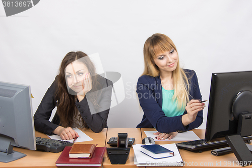 Image of Two girls looking at computer screens, one joy, the second upset