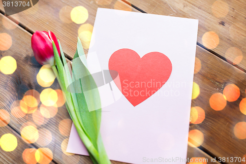 Image of close up of flowers and greeting card with heart