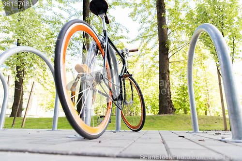 Image of close up of bicycle locked at street parking