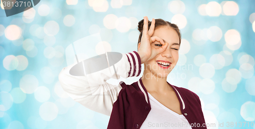 Image of happy teenage girl making face and having fun